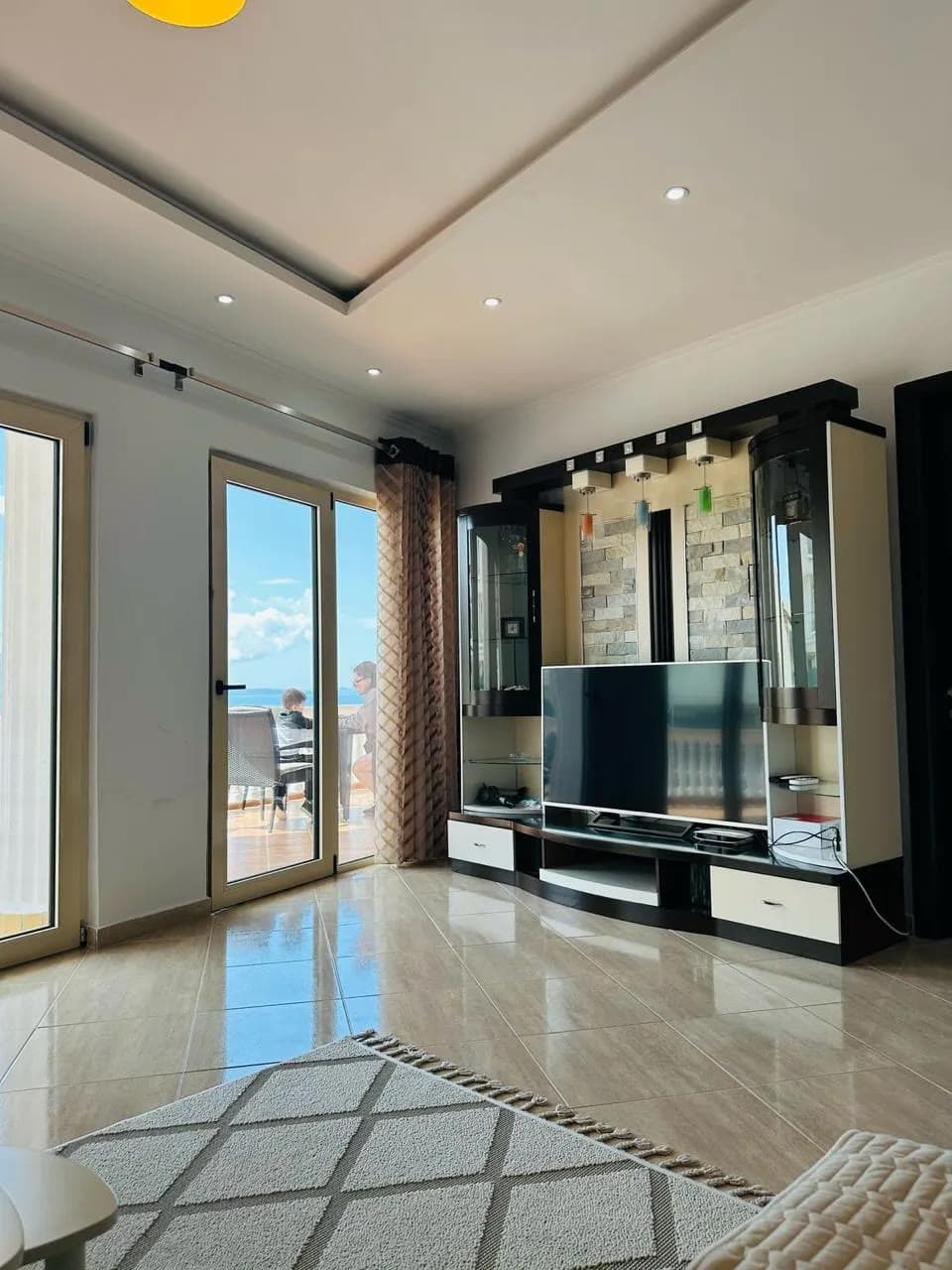 Living room of the Bougainville Bay 2BR opening onto a sea terrace, Sarandë