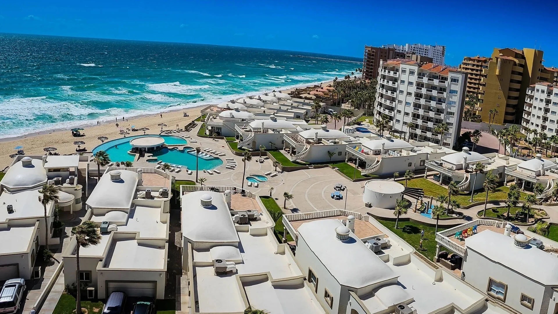 Las Palmas villas, pools, and Sandy Beach shoreline