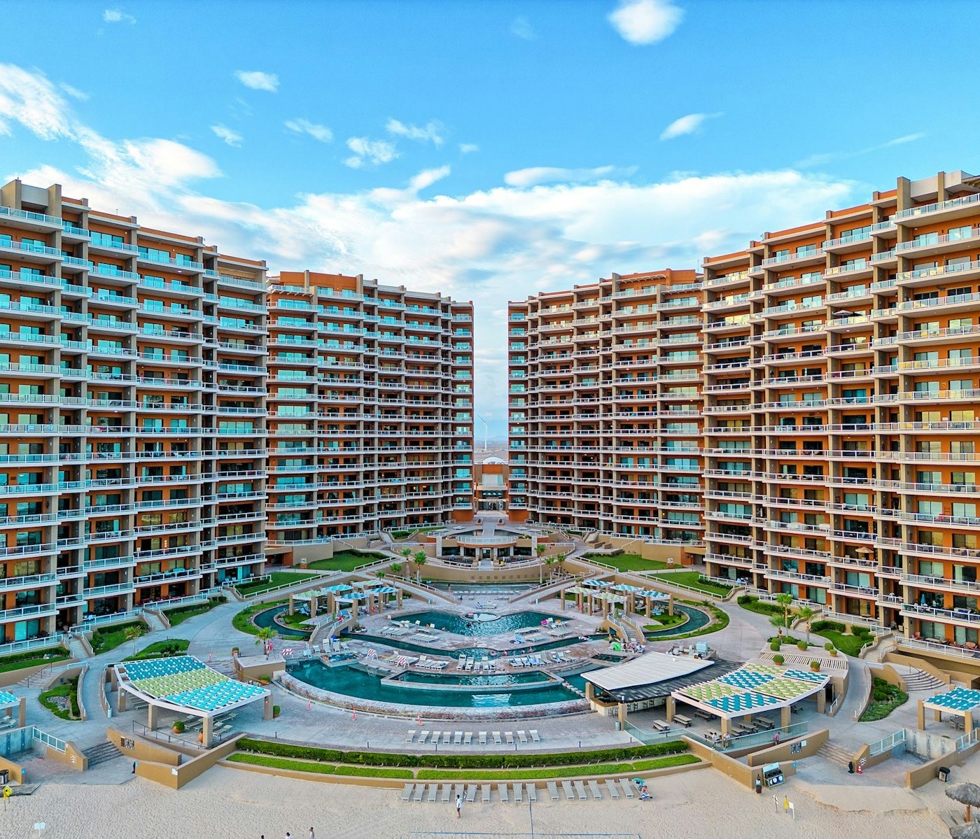 Las Palomas Beach & Golf Resort towers and pool courtyard on Sandy Beach