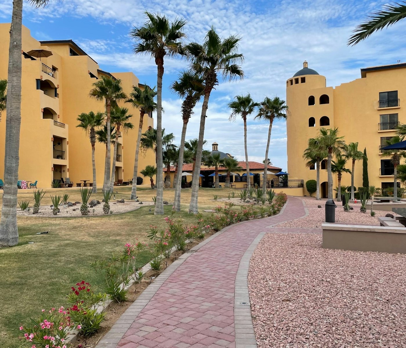 Courtyard and yellow mid-rise buildings at Princesa de Peñasco