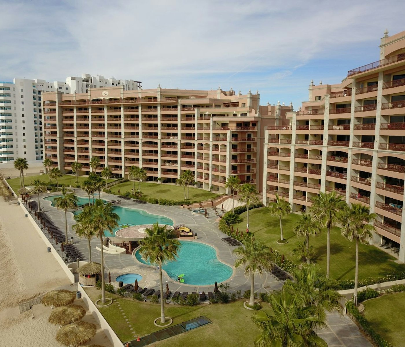 Sonoran Sun towers, pools, and beach palapas on Sandy Beach